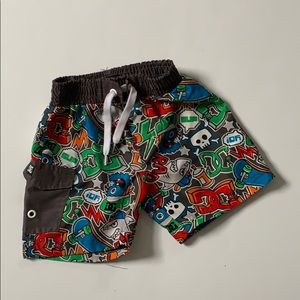 DC swimming trunks with sharks and skateboards